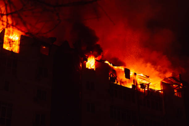 istock Burning house is engulfed in flames at night. 2106484083