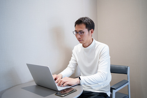 Asian man using laptop