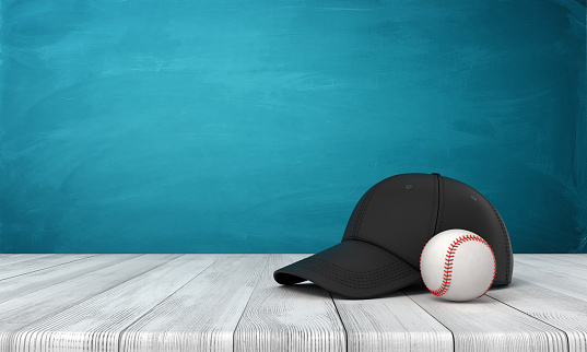 3d rendering of a baseball and a black baseball cap lying on wooden surface near blue wall with some copy space. Sports and games. Sportswear. Hobbies and leisure.