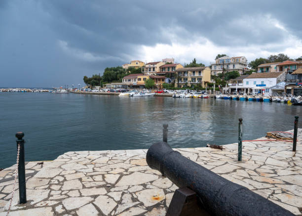 View across walkway to calm bay and town, dramatic sky