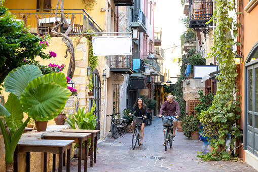 Couple explores old village streets on bicycles