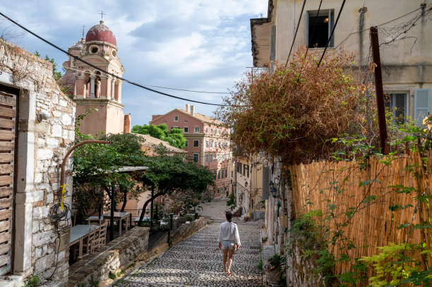 istock Woman explores old town streets 2106549677
