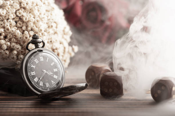 Antique clock and accessories, old and beautiful clock and accessories on rustic wood and dark background, selective focus.