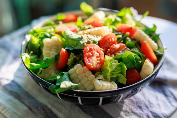 Fresh vegan vegetarian salad and vegetables. Southwestern salad with avocado, corn, tomato, and red bean. Food. Diet. Healthy eating. Rustic.