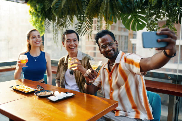 istock Man Taking Selfie with Friends 2106610838