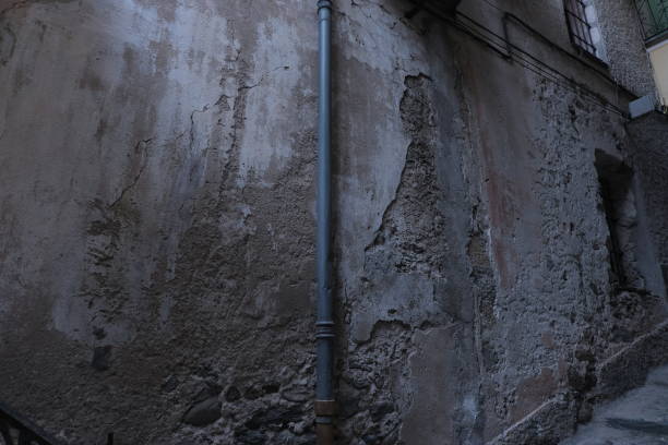 Copper pipes exposed in a colorful alley