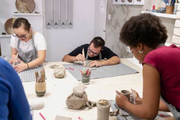 istock Young people with Down Syndrome at ceramics workshop 2106652132