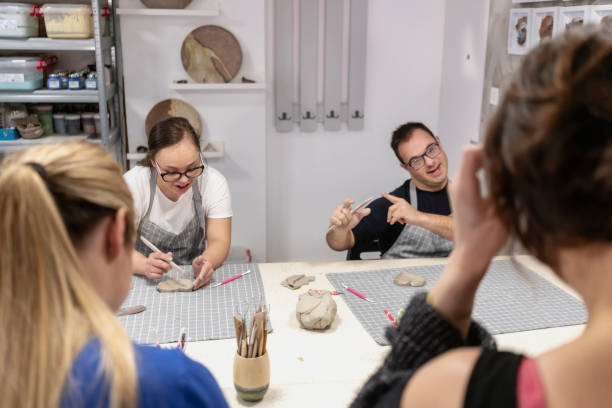 istock Young people with Down Syndrome at ceramics workshop 2106652640