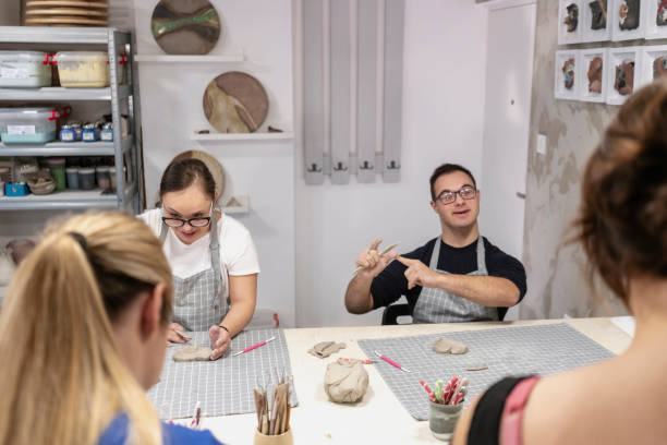 istock Young people with Down Syndrome at ceramics workshop 2106652642