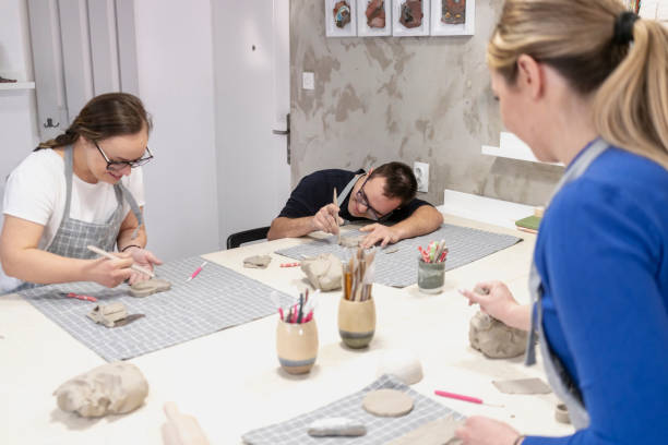 istock Young people with Down Syndrome at ceramics workshop 2106654688
