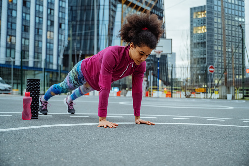 Female multiracial athlete exercising in the city