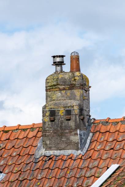 istock chimney on a roof with clay tiles 2106662386