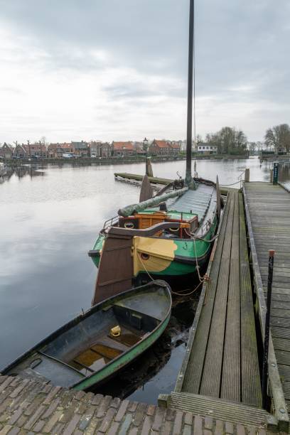 istock hellish flat-bottomed ship at the jetty 2106676755