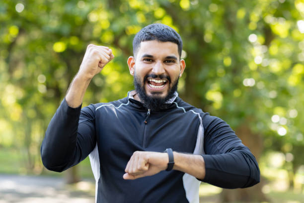 istock Energetic man celebrating success with a power gesture in the park 2106693818