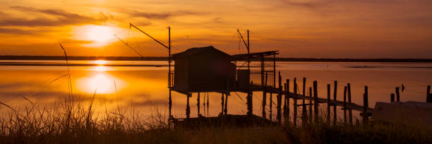 istock sunset at Pialassa Baiona near Marina Romean (Italy) 2106761653