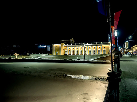 night view of the Philharmonic Hall in winter on the river bank