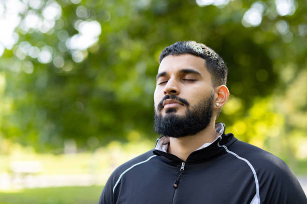 istock Man in contemplation at serene park setting 2106788575