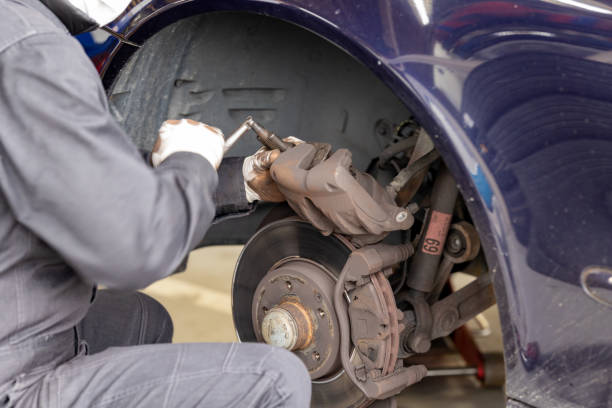 istock Brake pad replacement and maintenance mechanic 2106796392