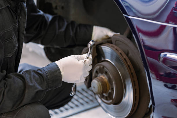 istock Brake pad replacement and maintenance mechanic 2106796394