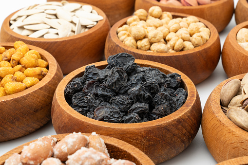 Healthy dried nuts and fruits in wooden bowl.
