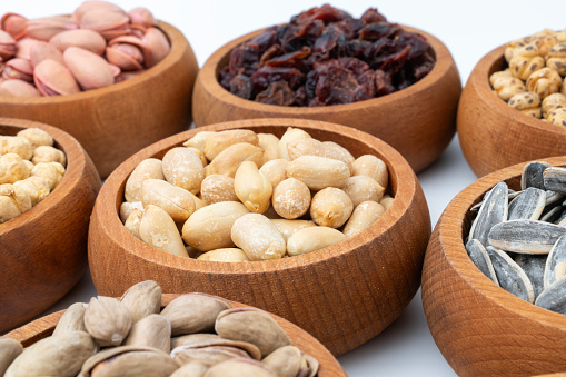 Healthy dried nuts and fruits in wooden bowl.