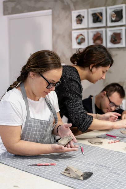 istock Young people with Down Syndrome working with clay 2106824197