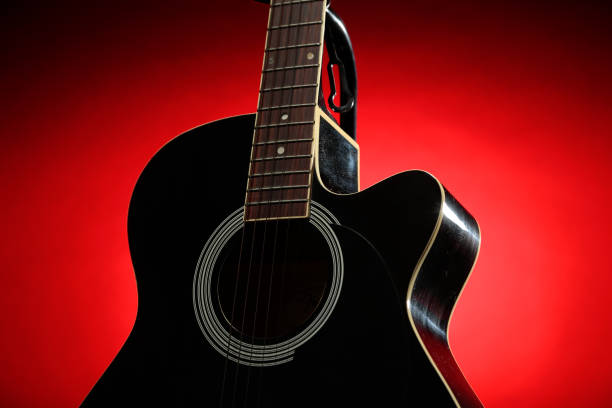 istock Black acoustic guitar photographed with color lighting 2106825317