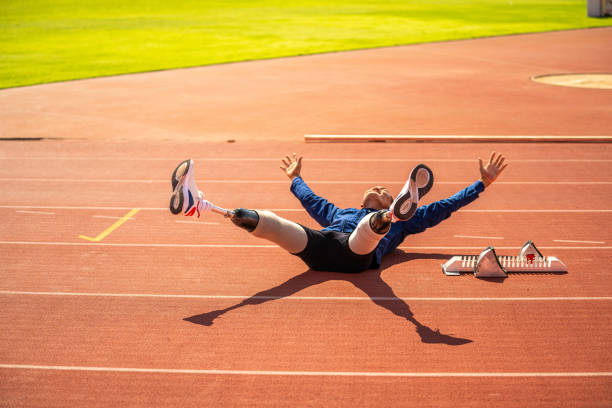 Below view of a young female athlete in a long jump.