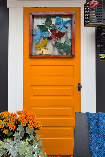Bright orange decorative door. Front home entrance
