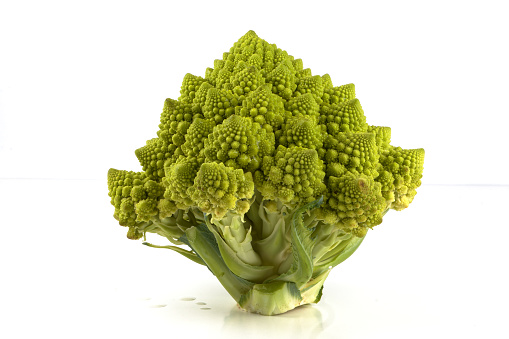 a biological example of Fibonacci spirals and fractals in nature using a Romanesco cauliflower isolated on a white background and with real shadows