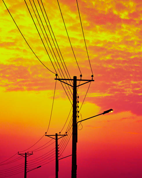 istock Electricity Poles Silhouetted Against Dusk Sky 2106840567