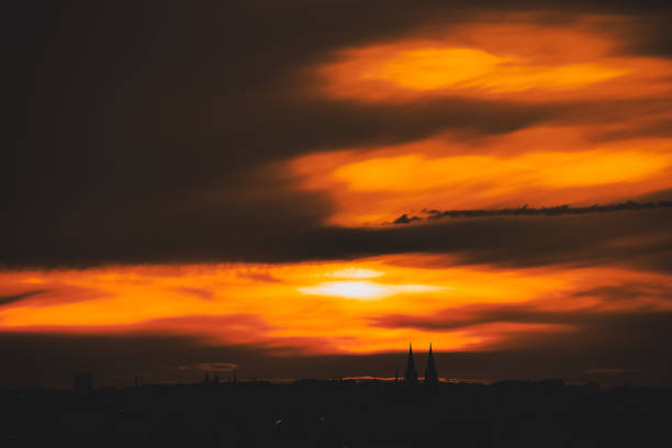 Prague castle in silhouette against a dramatic sky