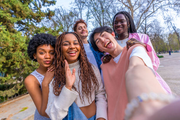 istock Japanese young man taking selfie with multi-ethnic friends 2106852910