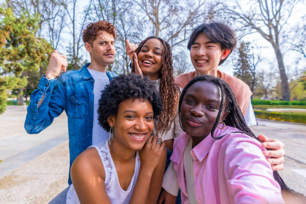 istock Happy diverse friends taking a group selfie in a park 2106855100