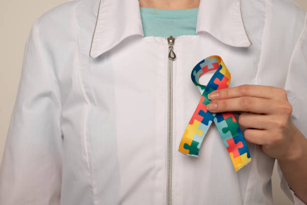 istock World Autism awareness and pride day with Puzzle pattern ribbon. The doctor's hand 2106862152