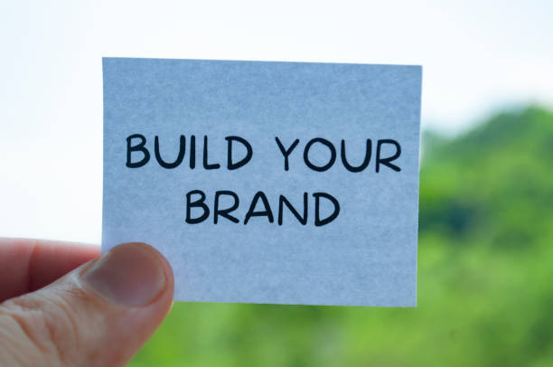 istock Build your brand text on white paper notepad with nature background. Branding concept 2106867561