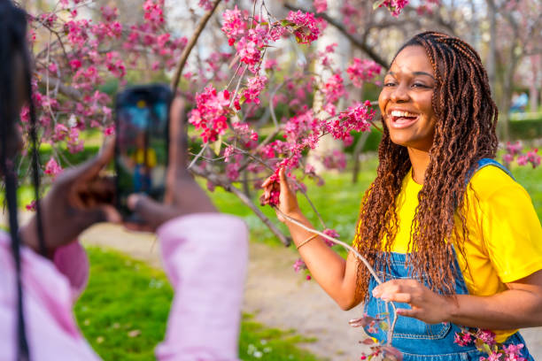 istock Friends taking photos next to a cherry tree in spring 2106868117