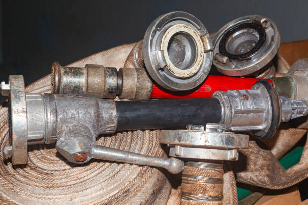 istock Twisted old fire hoses with connections and nozzles. 2106870816