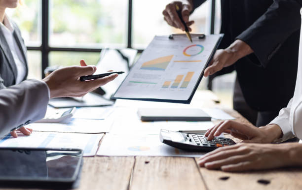 istock Meetings to discuss investment advisors together analyzing financial data, business growth graphs and charts, and planning business strategies. 2106880978