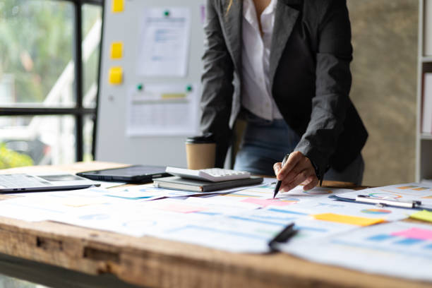istock Businesswoman working on financial documents in the office analyzing investment statistical data. 2106880979