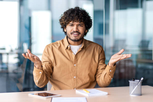 istock Confident indian businessman gesturing during a meeting in modern office 2106883688
