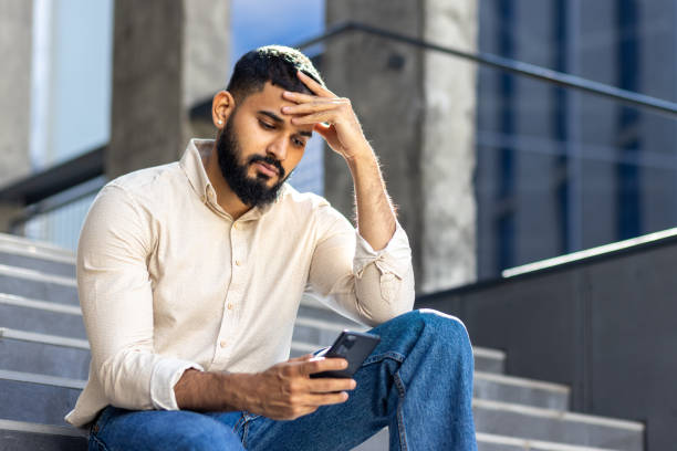 30+ Serious Businessman Sitting On Staircase Holding His Mobile Phone Stock Photos, Pictures & Royalty-Free Images - iStock
