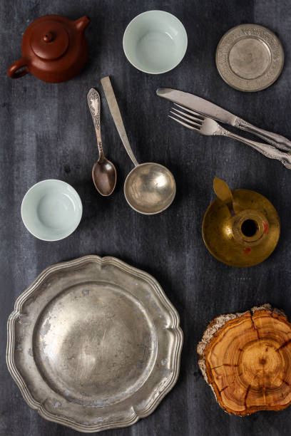 istock Various antique vintage dishes on black background 2106900509