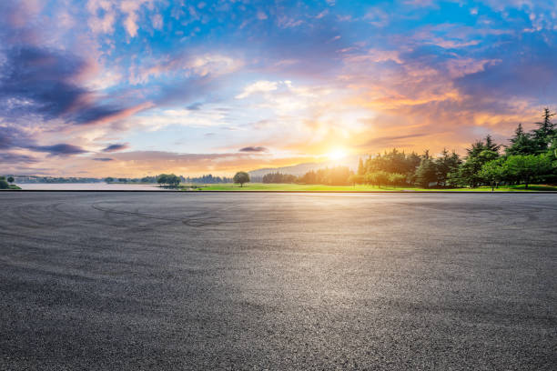 istock Asphalt road square and green forest natural landscape at sunset 2106903199