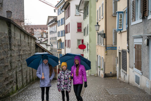 istock Family explores old town on a rainy day 2106905358