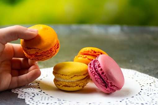 Macarons on a table with child hand