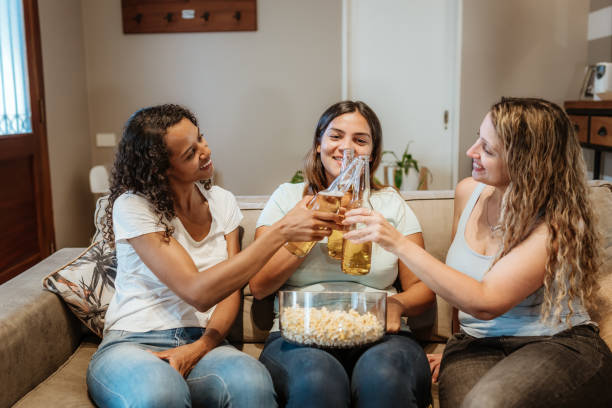 istock Friends Toasting With Beer Over Popcorn at Home 2106941095