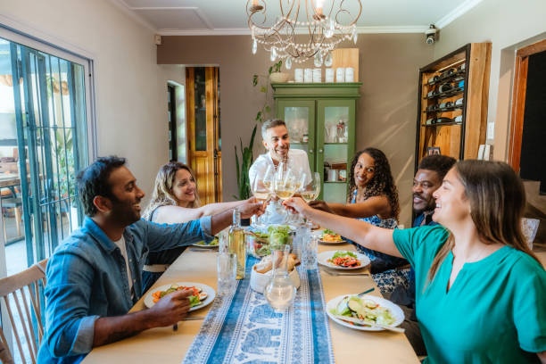 istock Friends Toasting Wine at Dinner Party at Home 2106942187