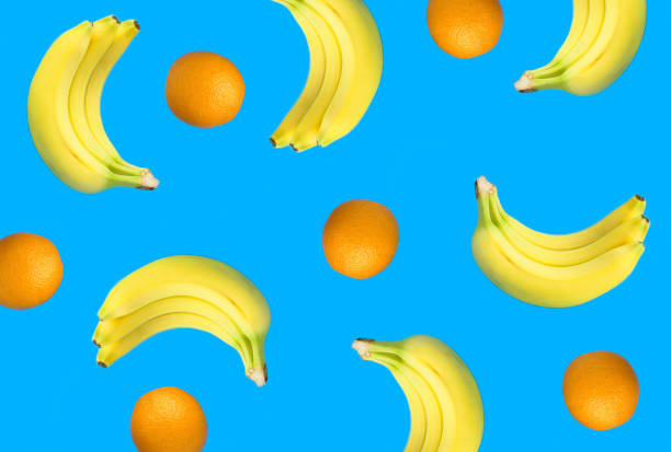 istock Banana and orange on the blue background. Flat lay. Top view. 2106960340