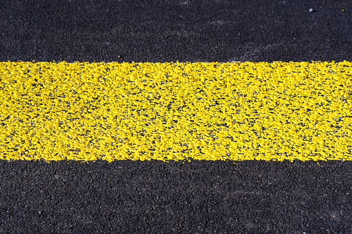 High angle close-up view of yellow zebra crossing road marking at Swiss City of Zürich on a sunny spring day. Photo taken March 23rd, 2024, Zurich, Switzerland.
